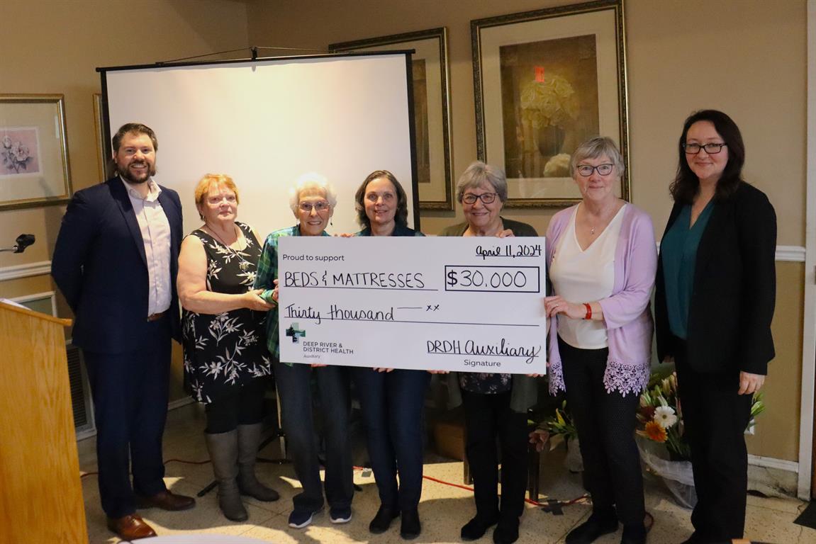 Pictured here presenting the second of the three donations provided is William Willard - DRDH Executive Vice President and CFO, Auxiliary Members Eileen Burke, Ethel Lee, Lise Hunter, Gloria Kendrick, Maureen Bakewell, and Janna Hotson – DRDH President and CEO 